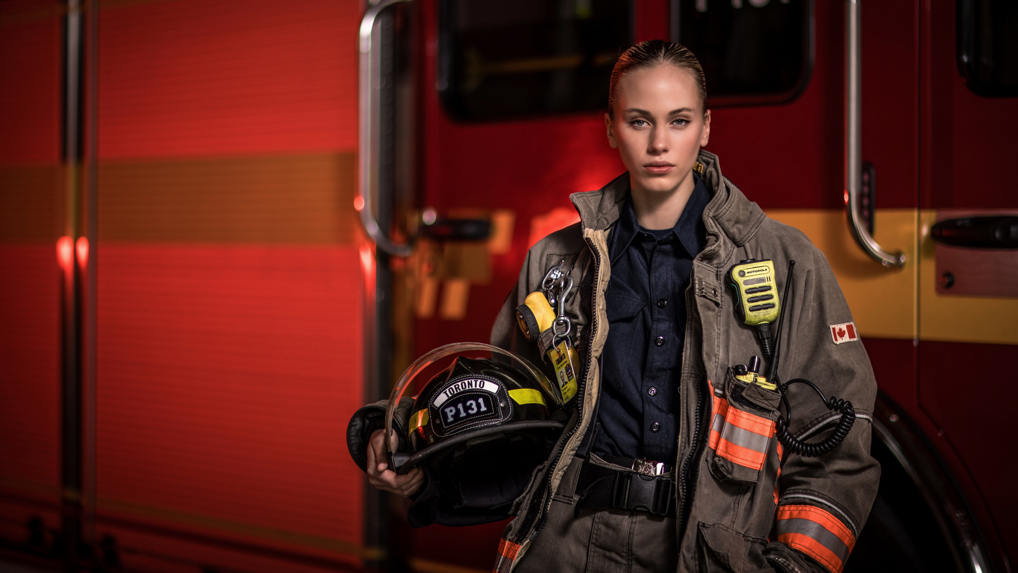Alivia Croal Founder of Grand Girl Clothing in Firefighter Uniform Modelling in front of a Firetruck